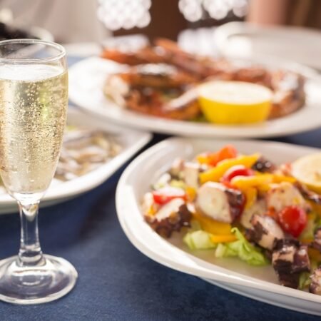 Italian cuisine. Glass of prosecco and variety of seafood. Shallow DOF horizontal